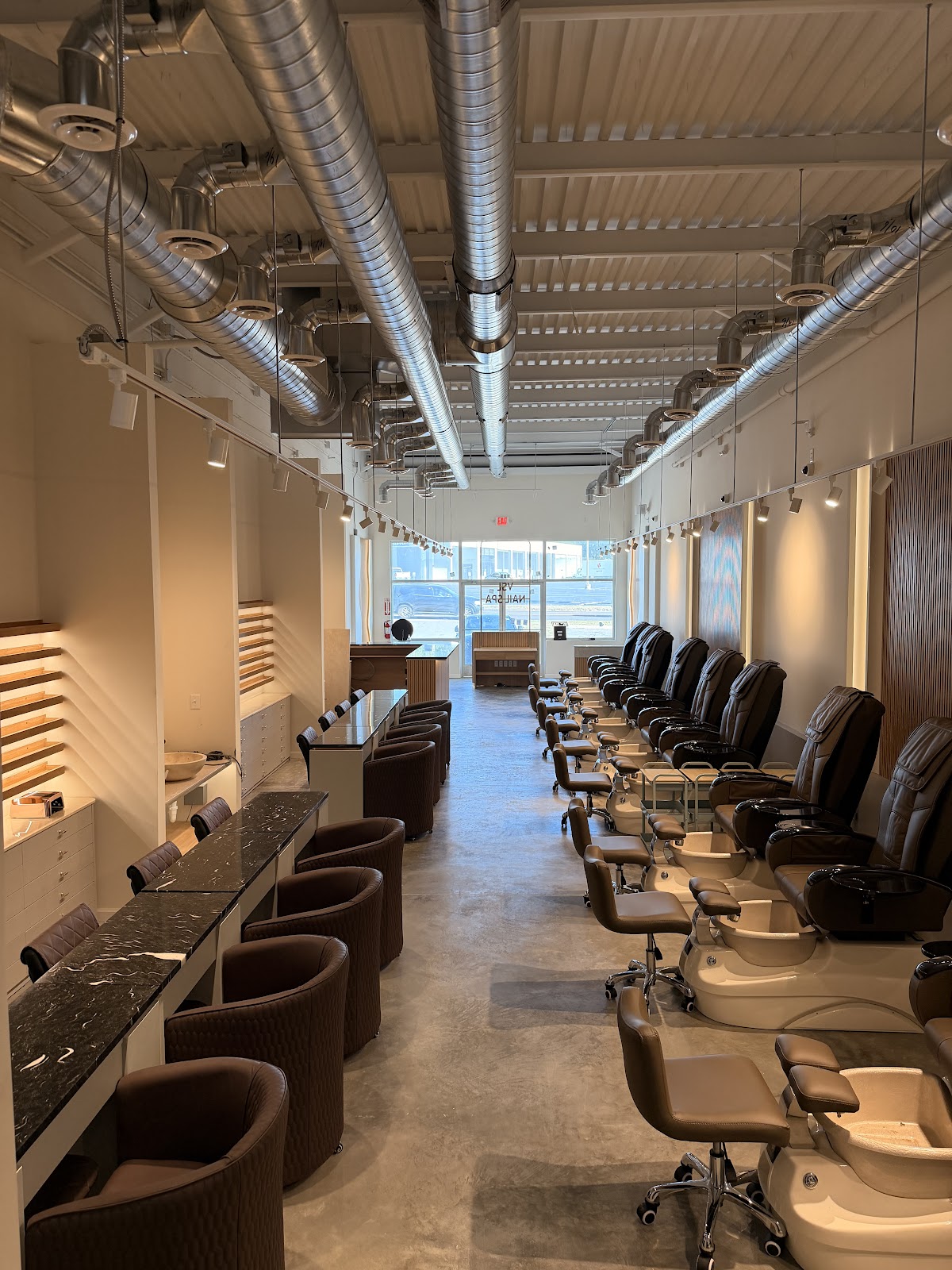 Full salon floor — manicure bar and pedicure chairs